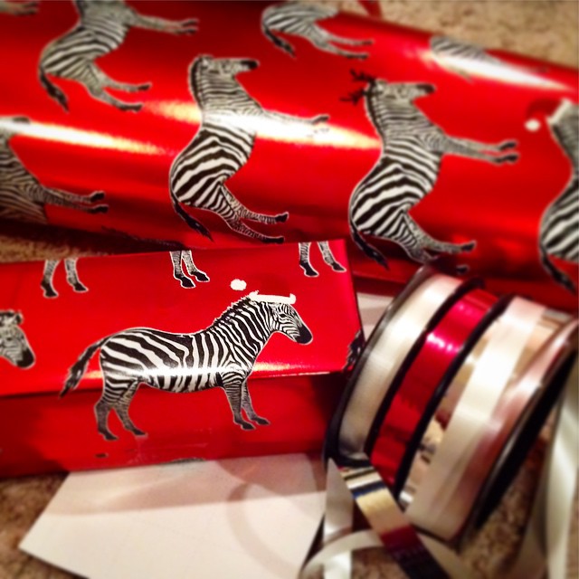 The best wrapping paper :: from my husband #zebras #wrappingpaper #santa #christmas #2014 #ypsi #ypsilanti #kellycaroline #michigan #gifts #ribbon #red #blackandwhite #classy #metallic #hats #animals #wild
