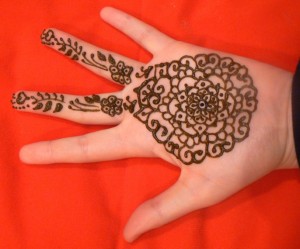 circular henna pattern, palm design, hand