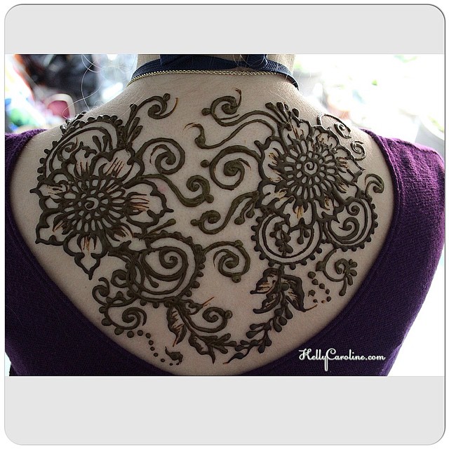 One of my favorite henna back tattoo designs. She was wearing the perfect shirt for her henna appointment. #henna #mehndi #tattoos #tattoo #design #art #artist #kellycaroline #michigan #michiganhennaartist #hennadesigns #backtattoo #flowers #tats