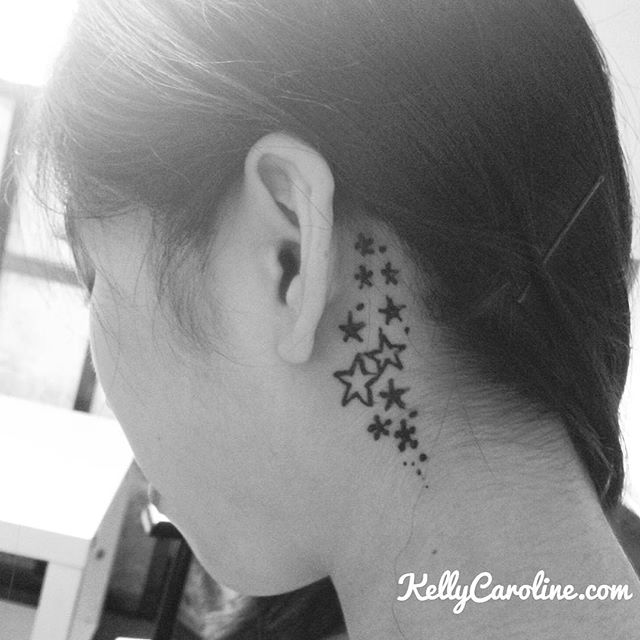 A little cute henna behind the ear tattoo of stars falling . So pretty